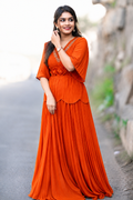 Elegant Orange Pleated Maxi Dress with Floral Waist Detailing
